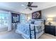 Spacious bedroom with windows offering natural light, ceiling fan, and decorative artwork at 3308 Oleander Dr, Hernando Beach, FL 34607