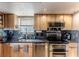 Modern kitchen features stainless steel appliances, granite countertops, and natural wood cabinetry at 3308 Oleander Dr, Hernando Beach, FL 34607