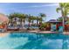 Relaxing pool with tropical landscaping, a tiki hut, and a beautiful waterfront view at 3308 Oleander Dr, Hernando Beach, FL 34607