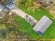 The home as seen from above features lush, green grounds and plenty of trees for privacy at 3323 Parlow Ave, Spring Hill, FL 34606