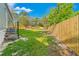 The backyard includes a wooden fence, grassy lawn, and metal stairs for easy access to the home at 3323 Parlow Ave, Spring Hill, FL 34606