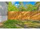 A spacious backyard featuring a newly installed wooden fence and lush green grass for outdoor activities at 3323 Parlow Ave, Spring Hill, FL 34606