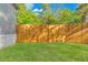 A spacious backyard featuring a newly installed wooden fence and lush green grass for outdoor activities at 3323 Parlow Ave, Spring Hill, FL 34606
