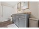 Bathroom featuring a dual sink vanity with gray cabinets, modern fixtures and a shower at 3323 Parlow Ave, Spring Hill, FL 34606