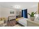 Cozy bedroom with hardwood floors, large windows, and stylish decor at 3323 Parlow Ave, Spring Hill, FL 34606
