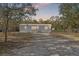 Charming single-story home with a well-maintained exterior and surrounded by mature trees providing a sense of privacy at 3323 Parlow Ave, Spring Hill, FL 34606