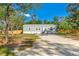 A charming home with a well-maintained lawn, gravel driveway, and a newly installed wooden fence at 3323 Parlow Ave, Spring Hill, FL 34606