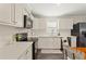 Modern kitchen featuring white cabinets, stainless steel appliances, and a breakfast bar area at 3323 Parlow Ave, Spring Hill, FL 34606