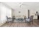 Bright living room featuring neutral walls, ceiling fan and modern furniture arrangement and hardwood floors at 3323 Parlow Ave, Spring Hill, FL 34606