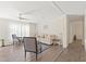 Bright living room with wood-look floors, a cozy sofa, and a view of the hallway at 3323 Parlow Ave, Spring Hill, FL 34606