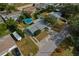 This aerial view shows a house with a gray roof, above ground pool, driveway, and a well-maintained landscape at 3540 Linkwood St, New Port Richey, FL 34652