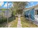 Backyard pathway leading through an arched trellis, with a partial view of the home at 3540 Linkwood St, New Port Richey, FL 34652