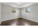 Light-filled bedroom with hardwood floors, and natural light from two windows at 3540 Linkwood St, New Port Richey, FL 34652