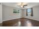 Spacious bedroom with hardwood floors, neutral walls, and a ceiling fan at 3540 Linkwood St, New Port Richey, FL 34652
