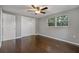 Bedroom featuring hardwood floors, a ceiling fan, closet, and a window providing natural light at 3540 Linkwood St, New Port Richey, FL 34652