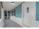 Inviting front entrance with a white front door, window, and covered porch at 3540 Linkwood St, New Port Richey, FL 34652