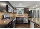Modern kitchen features stainless steel appliances, granite countertops, and dark wood cabinetry at 3540 Linkwood St, New Port Richey, FL 34652