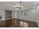 Bright living room featuring hardwood floors, a ceiling fan, and a decorative wall at 3540 Linkwood St, New Port Richey, FL 34652