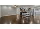 Hardwood floors throughout open-concept living space with stainless steel kitchen at 3540 Linkwood St, New Port Richey, FL 34652