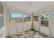 Bright enclosed porch with multiple windows, a door to the outside, and unique tile flooring at 3540 Linkwood St, New Port Richey, FL 34652