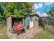 The backyard shed provides ample storage and is accompanied by a lawnmower at 3540 Linkwood St, New Port Richey, FL 34652