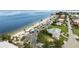 Coastal aerial view featuring a beautiful beach, convenient parking, and nearby residential properties with lush greenery at 3912 Rudder Way, New Port Richey, FL 34652