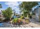 Lush backyard featuring a stone walkway, mature trees, and flowering plants and shrubs at 3912 Rudder Way, New Port Richey, FL 34652