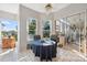 Bright breakfast nook features a round table, tile flooring, and sliding glass doors to the outdoor patio at 3912 Rudder Way, New Port Richey, FL 34652