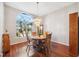 Charming dining room with wood floors, chandelier, and large window offering plenty of natural light at 3912 Rudder Way, New Port Richey, FL 34652