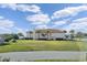 Rear exterior view of the two-story home with a large lawn and access to the ocean at 3912 Rudder Way, New Port Richey, FL 34652