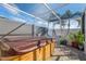 Enclosed patio featuring hot tub perfect for relaxing with palm tree views on a sunny day at 3912 Rudder Way, New Port Richey, FL 34652