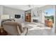 Comfortable living room with tile flooring, fireplace, built-in shelving, and abundant natural light at 3912 Rudder Way, New Port Richey, FL 34652