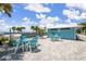 Inviting outdoor seating area with tables and chairs, ideal for enjoying the waterfront view and relaxing outdoors at 3912 Rudder Way, New Port Richey, FL 34652