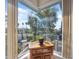 Cozy sitting area with a bay window, offering a view of the landscaped backyard and patio at 3912 Rudder Way, New Port Richey, FL 34652