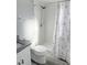 Bright bathroom featuring shower, toilet, vanity with granite counter, and decorative shower curtain at 4218 San Rafael Ave, New Port Richey, FL 34655