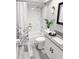 Neat bathroom featuring a tub and shower with a floral curtain and modern fixtures at 4218 San Rafael Ave, New Port Richey, FL 34655