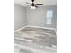 Bedroom with gray walls, gray wood-look flooring, a ceiling fan, and a window with blinds at 4218 San Rafael Ave, New Port Richey, FL 34655
