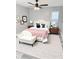 Inviting bedroom featuring a plush bed, decorative pillows, a ceiling fan, and a cozy bench at 4218 San Rafael Ave, New Port Richey, FL 34655