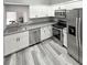 Modern kitchen featuring stainless steel appliances, gray countertops and white cabinetry at 4218 San Rafael Ave, New Port Richey, FL 34655