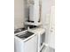 Laundry area with washer, dryer, water heater, shelving and utility sink at 4218 San Rafael Ave, New Port Richey, FL 34655