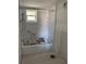 Bathroom shows tub/shower combo with grab bars and newly plastered walls at 4555 Marine Pkwy # 103, New Port Richey, FL 34652