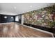 Large living room with wood flooring and a statement wall of floral wallpaper at 5973 Mckee Lake N Dr, St Petersburg, FL 33709