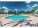 Community pool with surrounding patio and seating areas under sunny blue skies at 7343 Cleopatra Dr, Land O Lakes, FL 34637