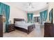 Bright main bedroom with fan, walk out to the lanai, and wood floors at 9033 Callaway Dr, Trinity, FL 34655