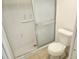 Bathroom featuring a shower with glass door and a standard white toilet at 9179 Gillmar St, Spring Hill, FL 34608