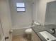 Well-lit bathroom featuring a granite vanity top, modern fixtures, and tub with shower at 9179 Gillmar St, Spring Hill, FL 34608