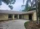 Single-story home featuring a driveway and attached garage at 9179 Gillmar St, Spring Hill, FL 34608