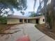 Charming single-story home with a spacious front yard and an attached two-car garage at 9179 Gillmar St, Spring Hill, FL 34608