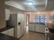 A well-lit kitchen with white cabinets, modern appliances, and plenty of counter space at 9179 Gillmar St, Spring Hill, FL 34608