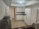 Bright kitchen featuring white cabinets, stainless appliances, and a tile floor at 9179 Gillmar St, Spring Hill, FL 34608